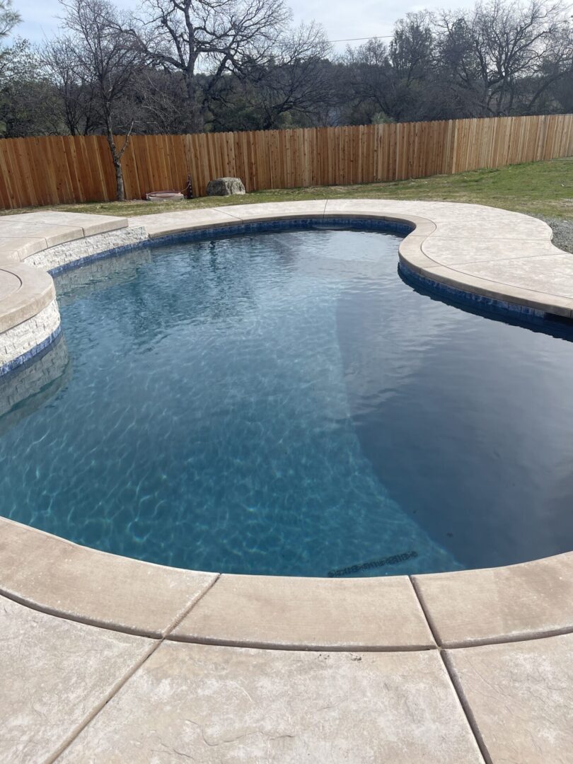 A small pool near a fence